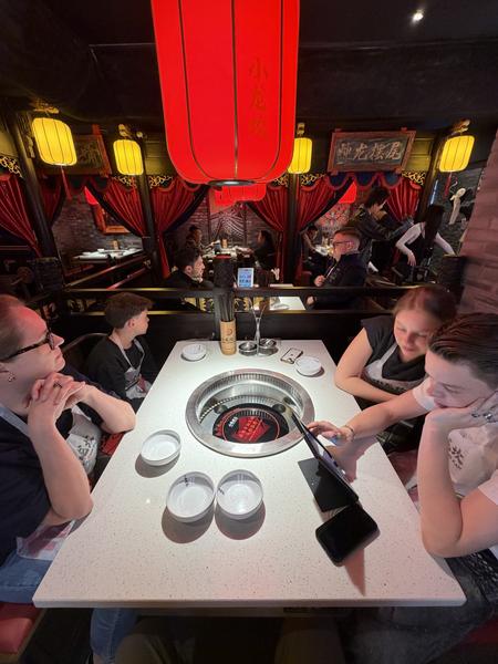 This photo captures a lively evening inside a hotpot restaurant located on Korte Leidsedwarsstraat, Centrum, Amsterdam